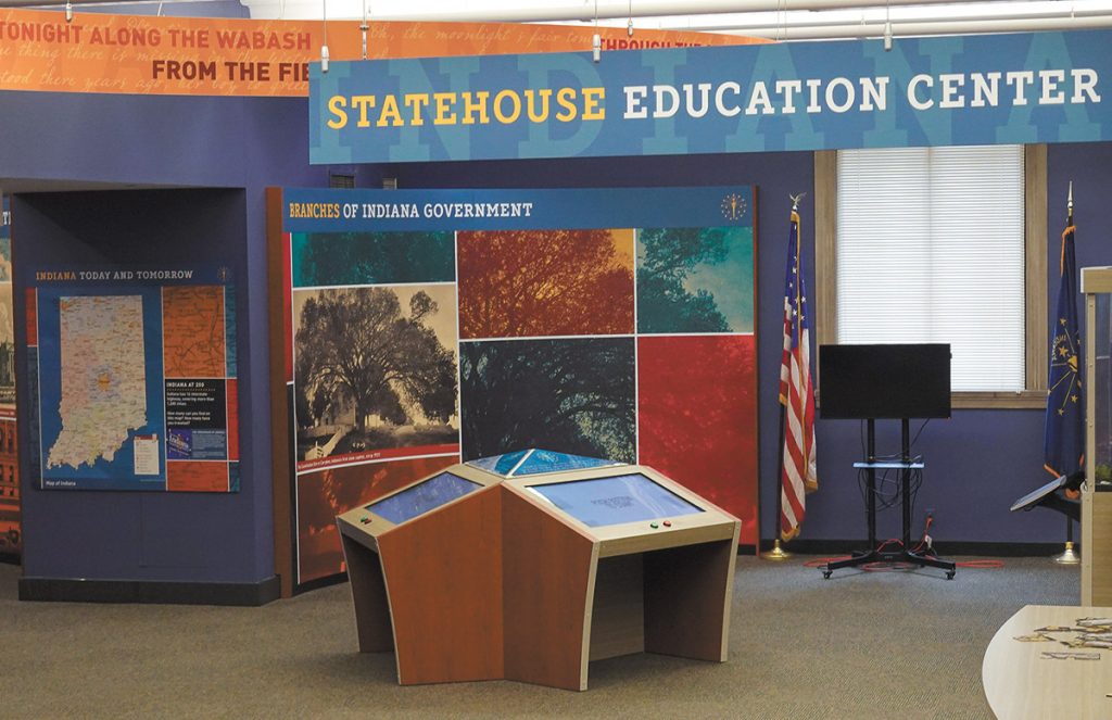 Photograph of the statehouse education center, several information stations are placed through the room